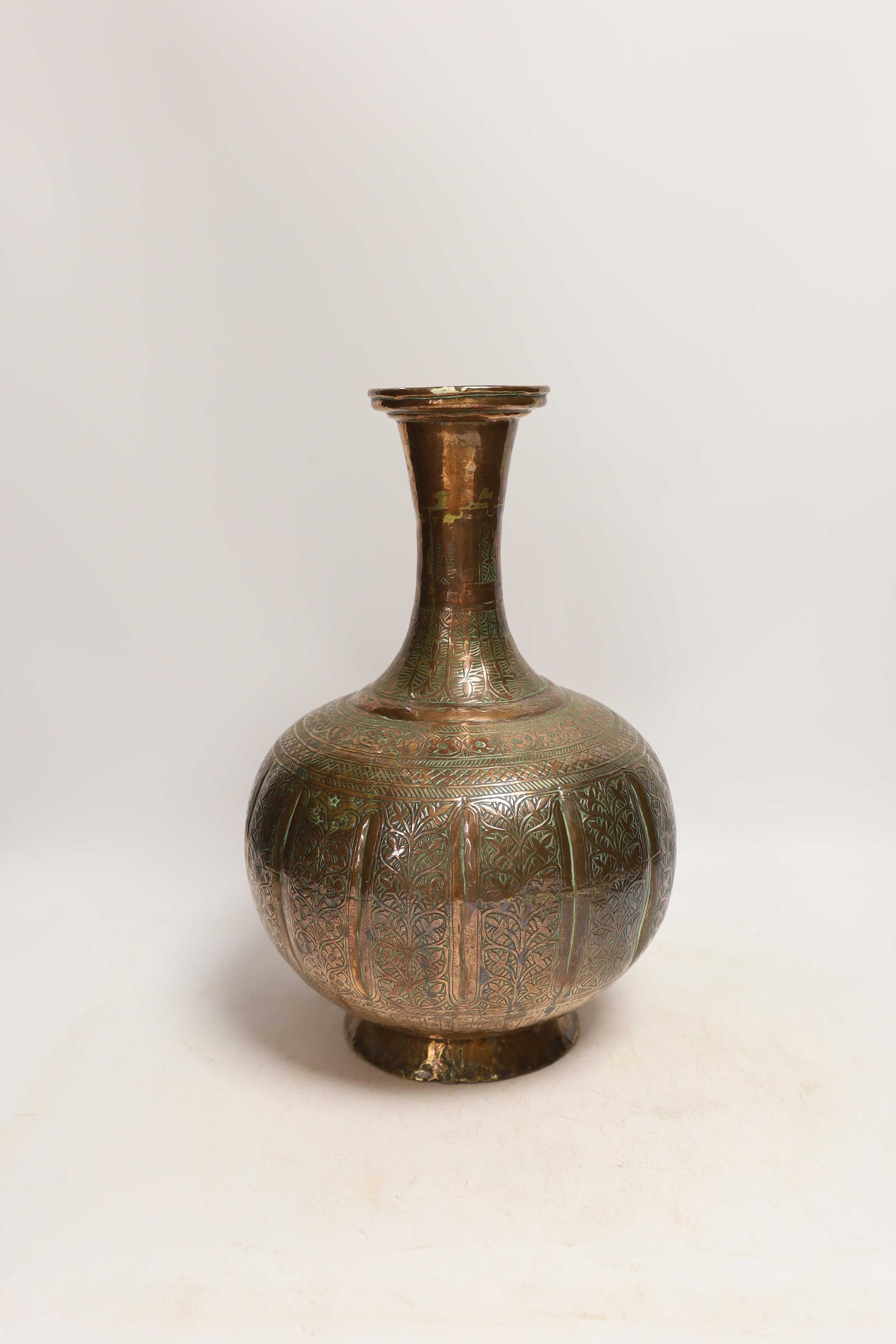 An Islamic engraved copper vase, 31cm